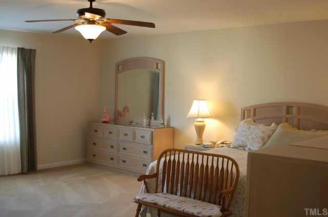 3616 Pinkham Way Raleigh, NC 27616 - Photo 5 of 7 a bedroom with a bed and a chandelier