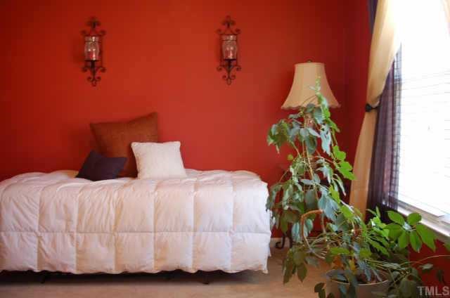 3616 Pinkham Way Raleigh, NC 27616 - Photo 6 of 7 a bedroom with a bed and a potted plant