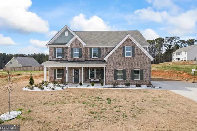 a front view of a house with yard and seating space