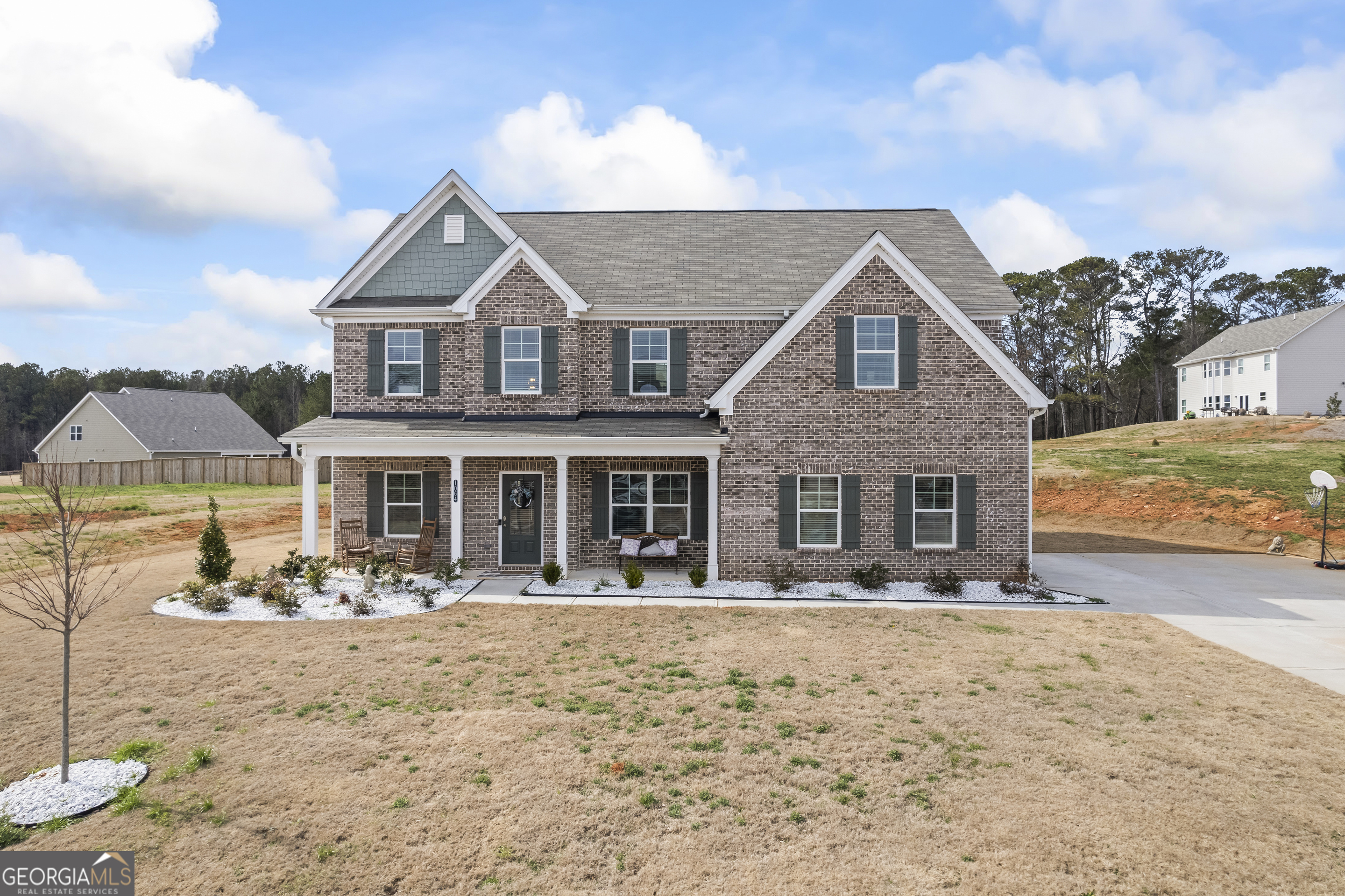 a front view of a house with yard and seating space