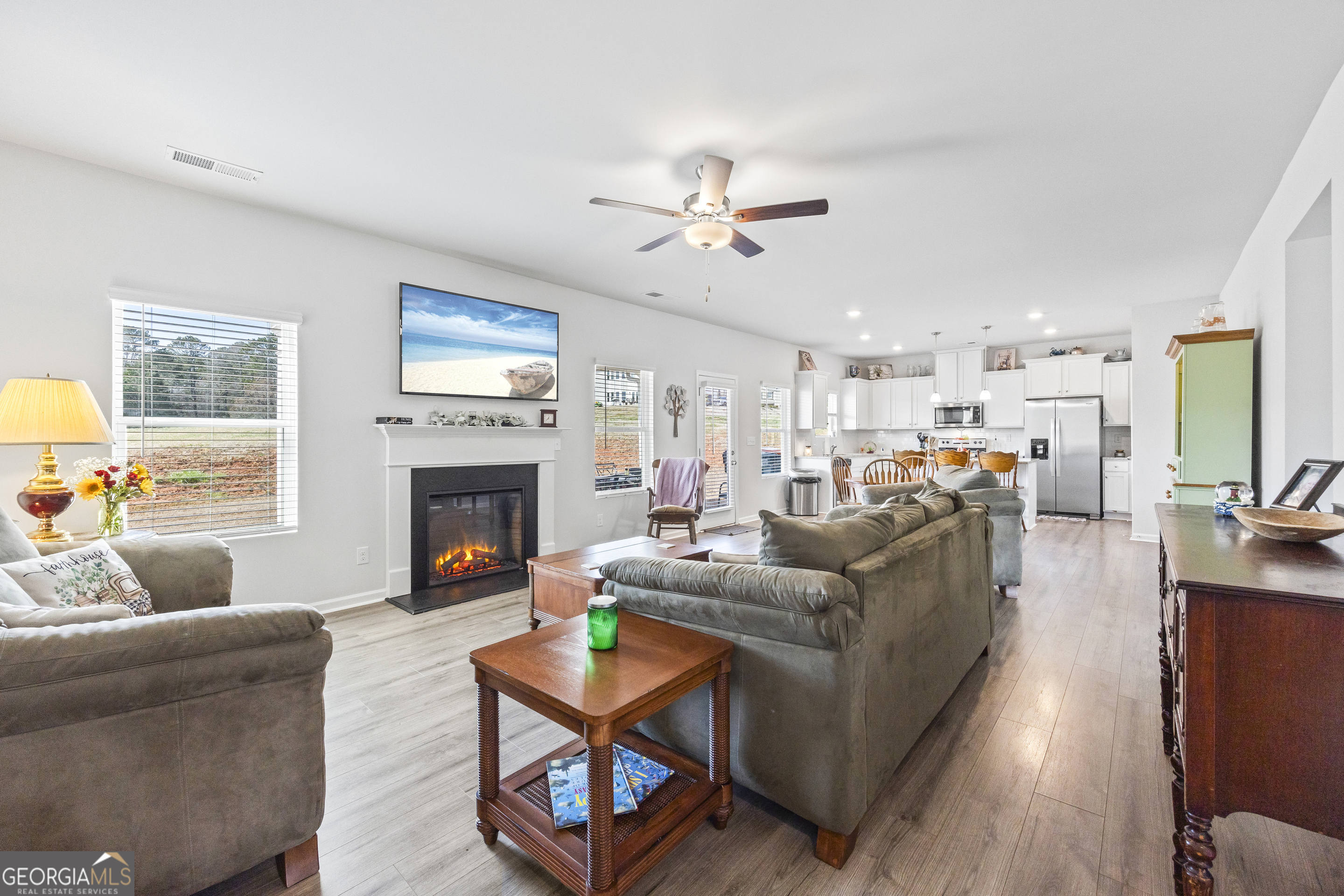 1064 Emmas Path Monroe, GA 30656 - Photo 14 of 55 a living room with furniture a fireplace and a flat screen tv