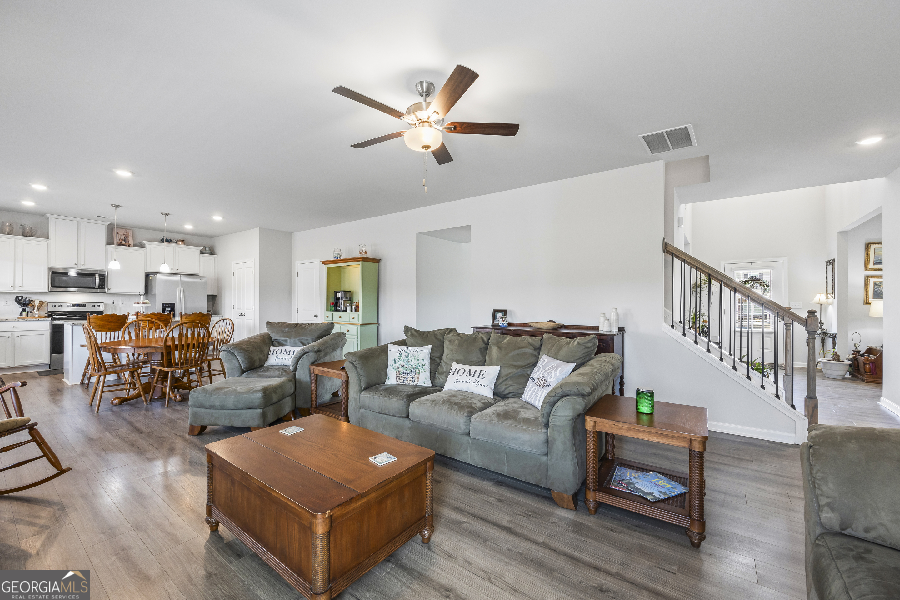1064 Emmas Path Monroe, GA 30656 - Photo 15 of 55 a living room with furniture kitchen view and a wooden floor