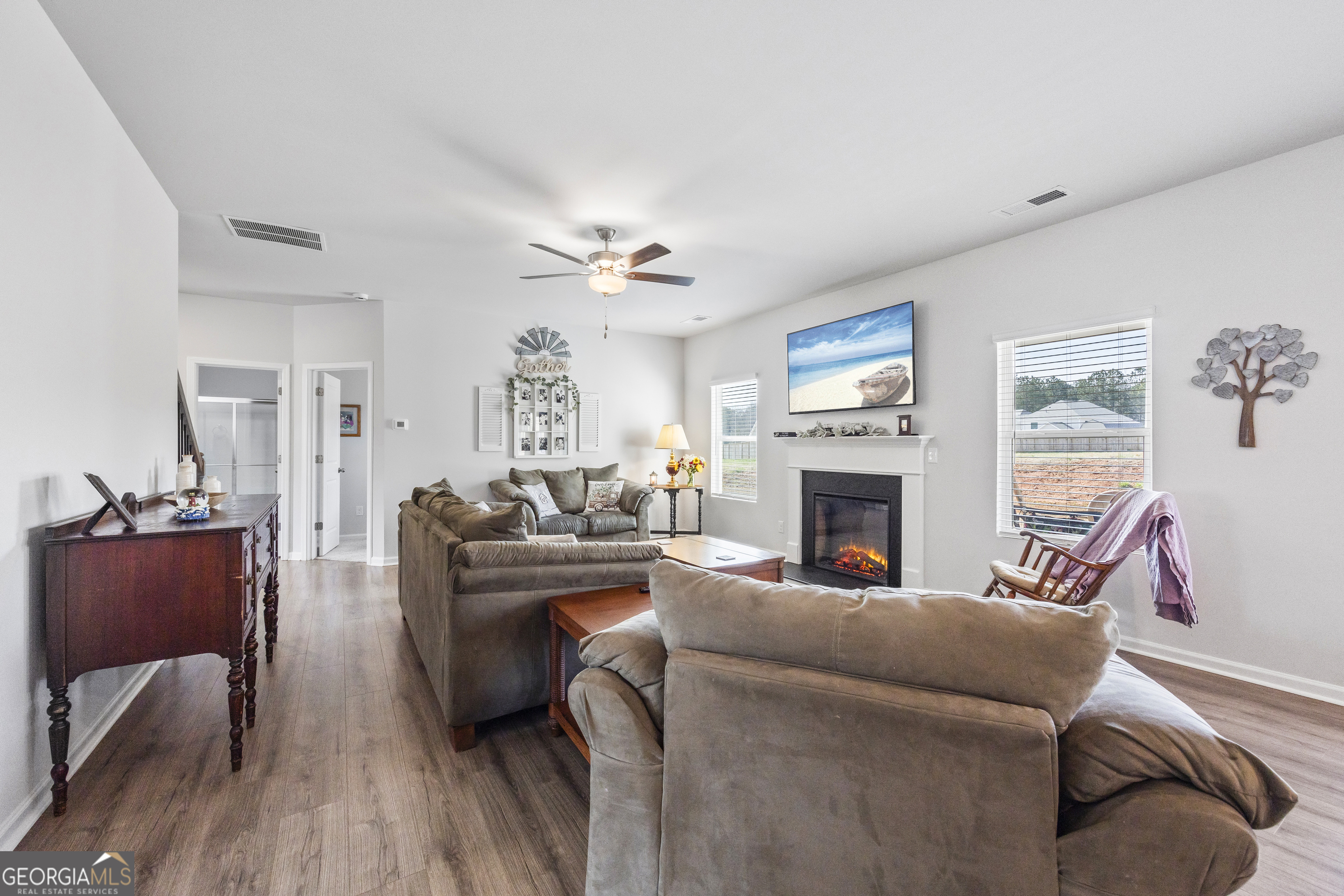1064 Emmas Path Monroe, GA 30656 - Photo 16 of 55 a living room with furniture a fireplace and a flat screen tv
