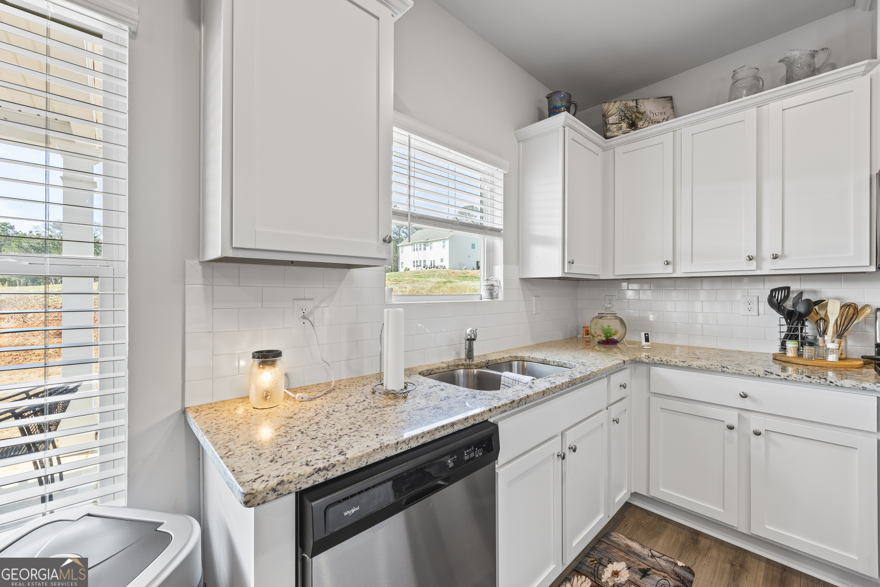 1064 Emmas Path Monroe, GA 30656 - Photo 22 of 55 a kitchen with a sink dishwasher window and cabinets