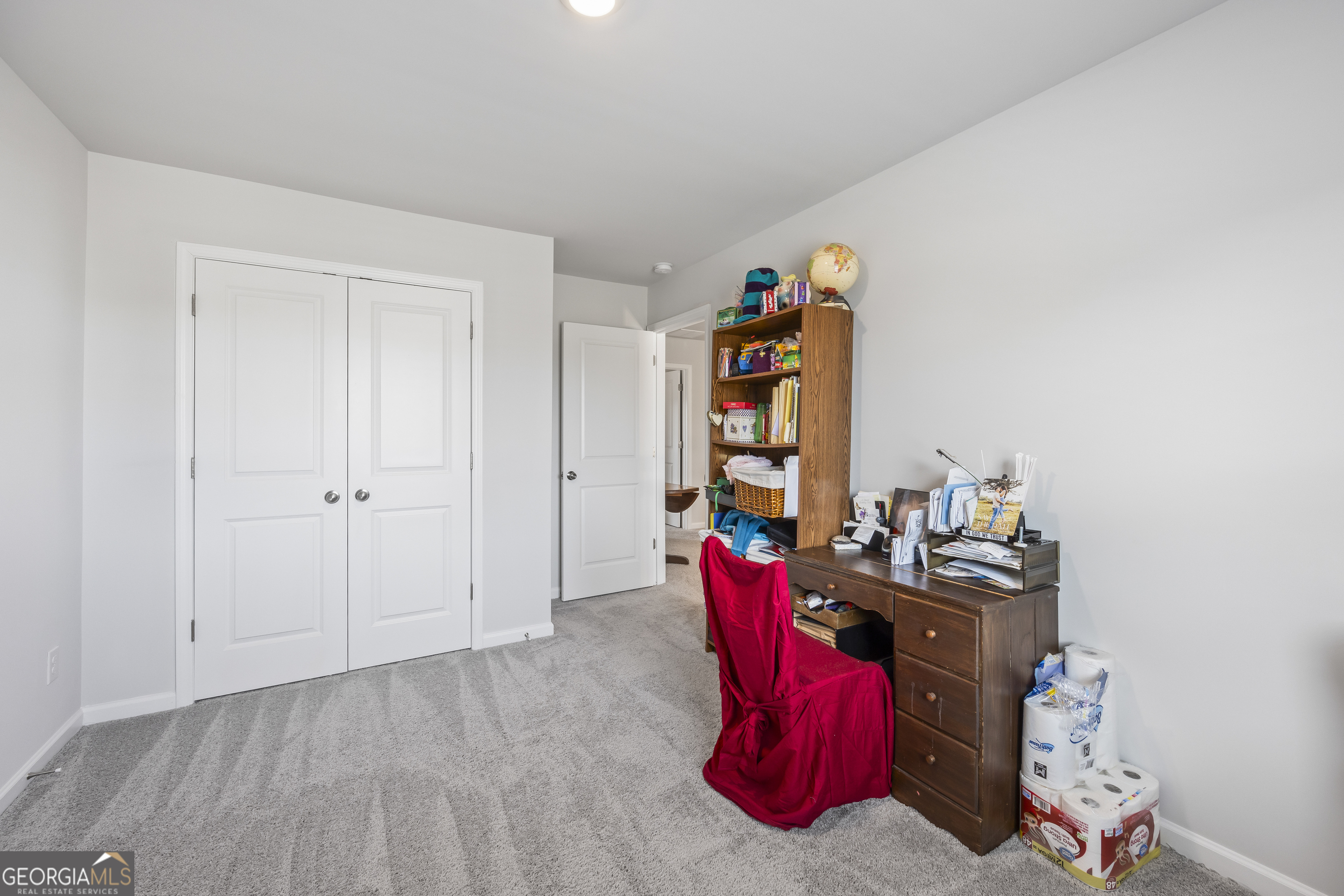 1064 Emmas Path Monroe, GA 30656 - Photo 24 of 55 a view of walk in closet with clothes and shoes