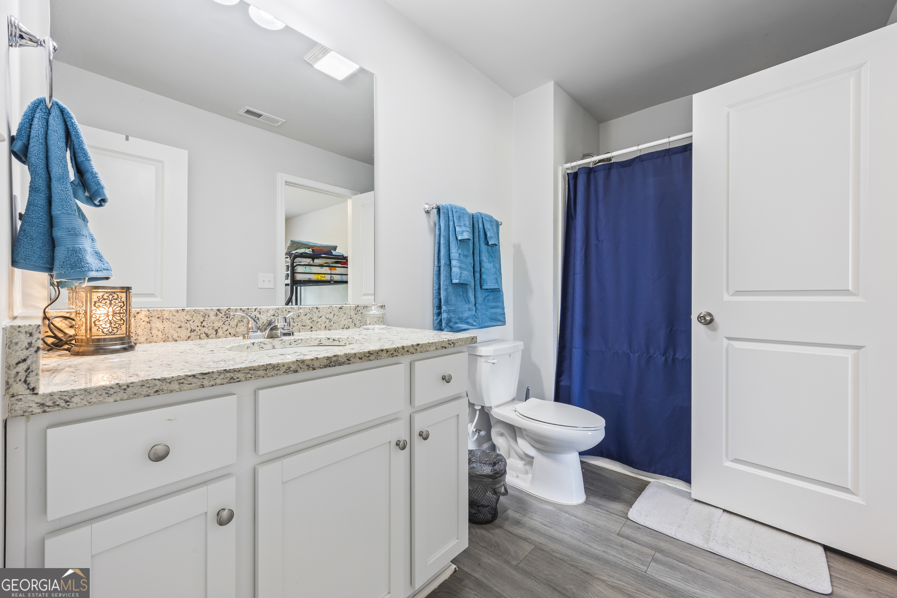 1064 Emmas Path Monroe, GA 30656 - Photo 25 of 55 a bathroom with a granite countertop toilet sink and a mirror
