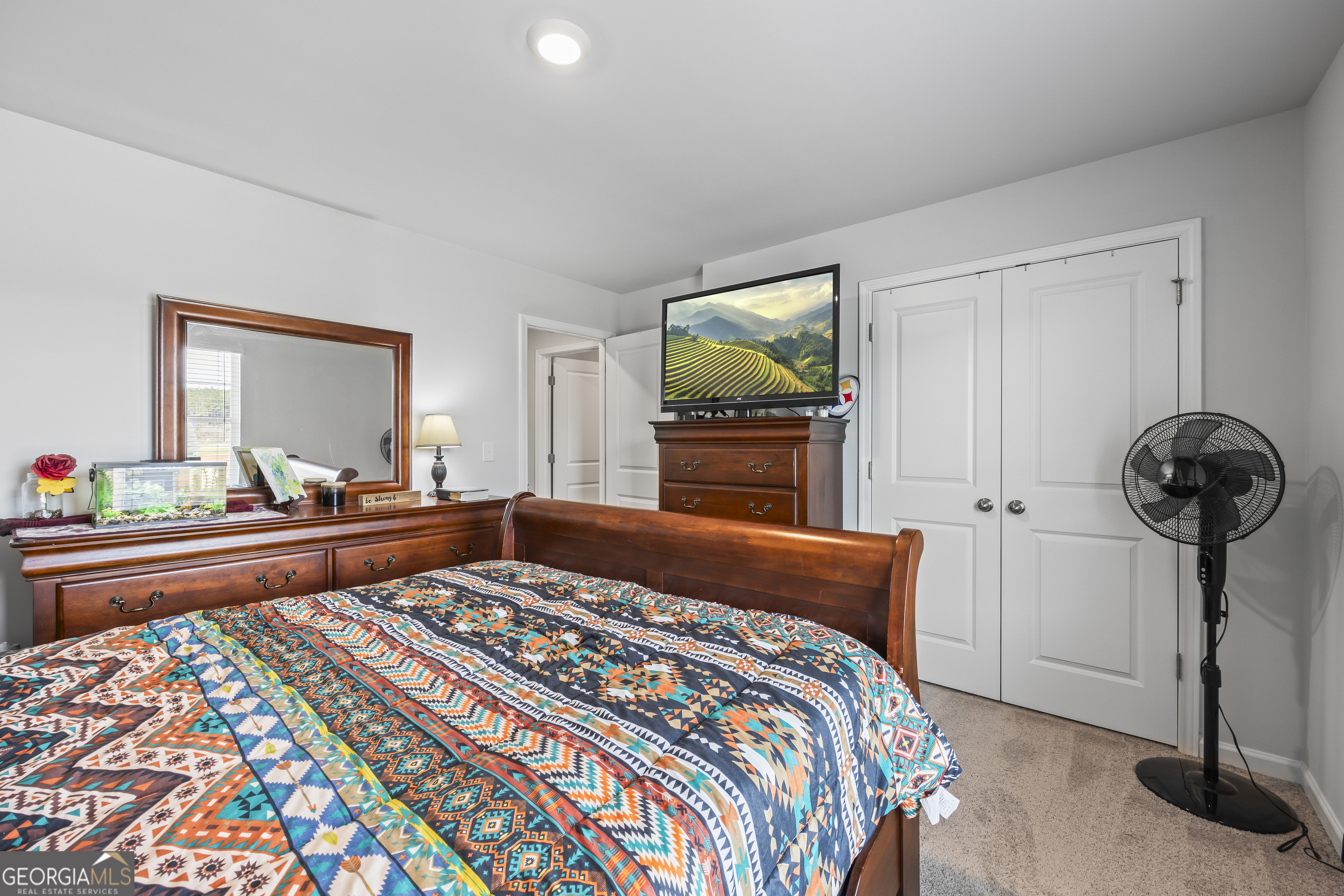 1064 Emmas Path Monroe, GA 30656 - Photo 31 of 55 a bedroom with a bed and a flat screen tv