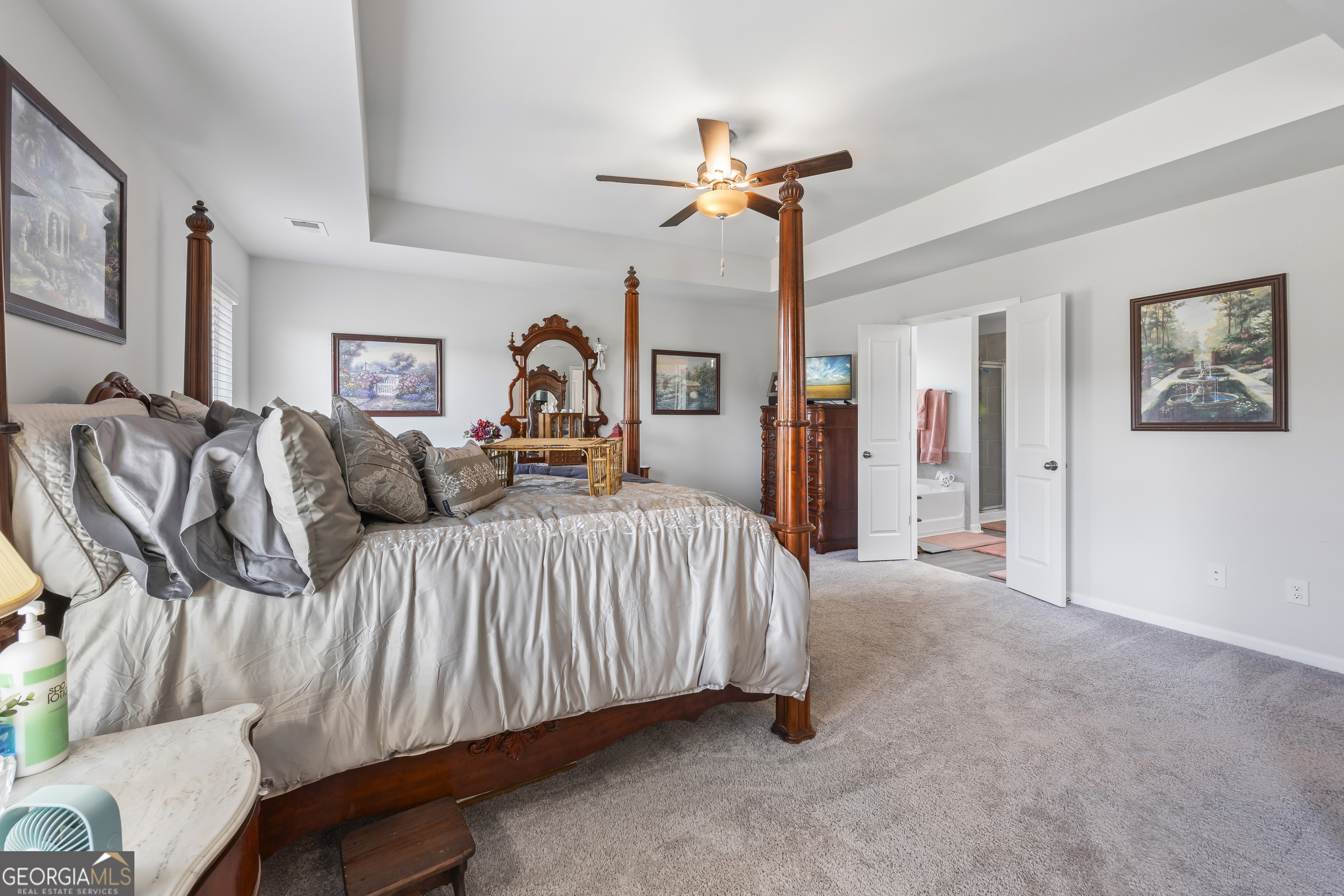 1064 Emmas Path Monroe, GA 30656 - Photo 33 of 55 a bedroom with a bed and a chandelier