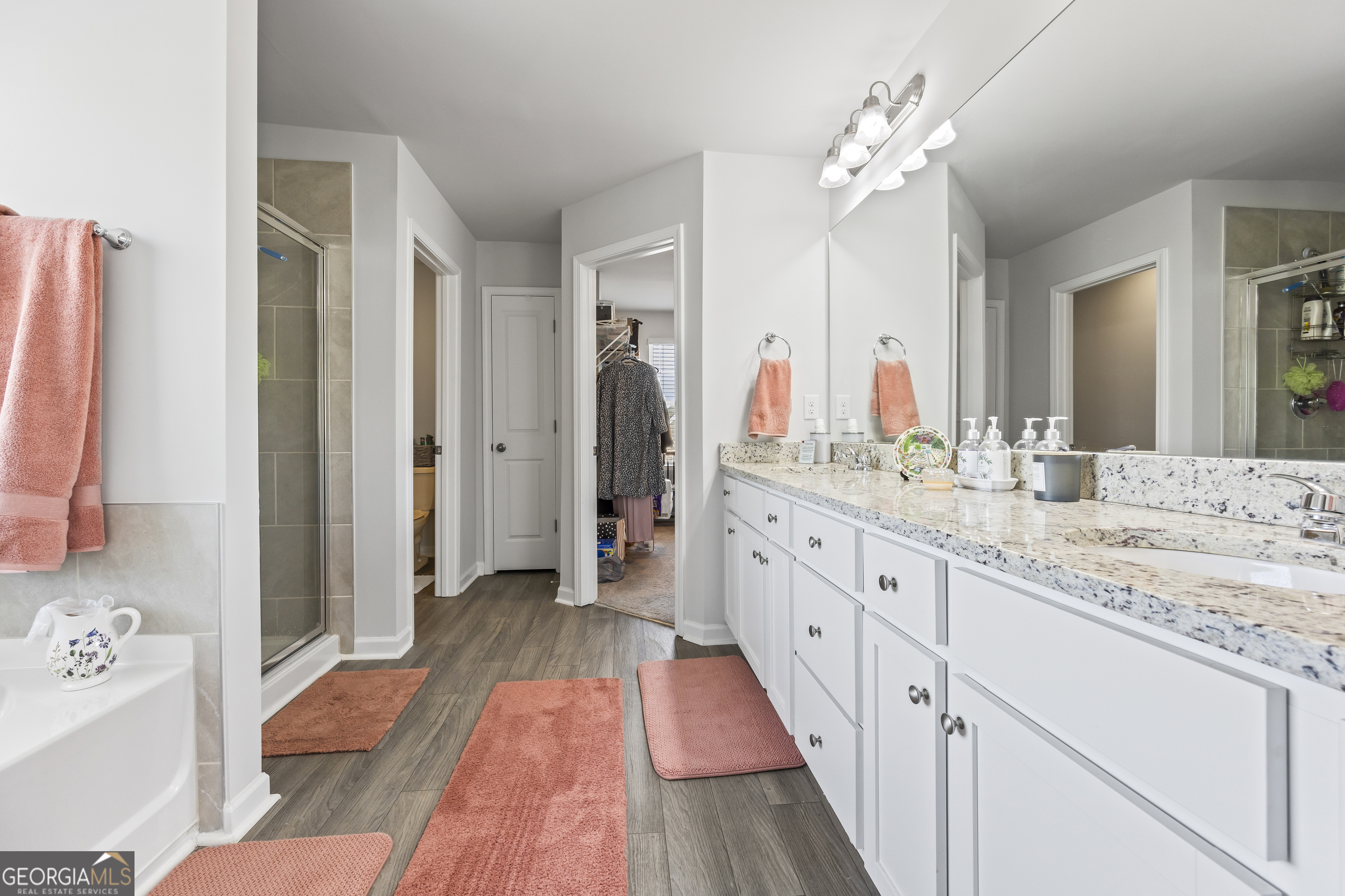 1064 Emmas Path Monroe, GA 30656 - Photo 36 of 55 a spacious bathroom with a double vanity sink and a mirror