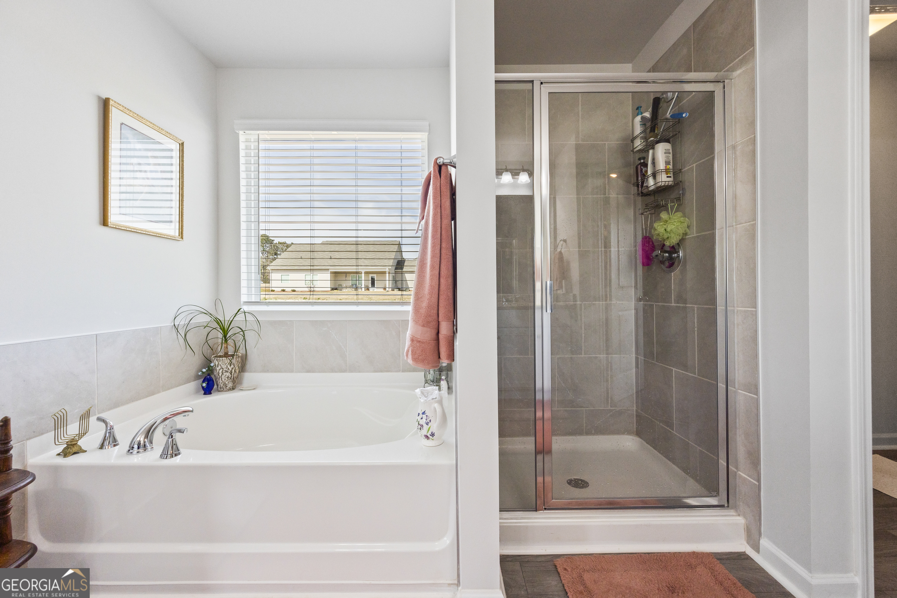1064 Emmas Path Monroe, GA 30656 - Photo 37 of 55 a white bath tub sitting next to a bathroom sink
