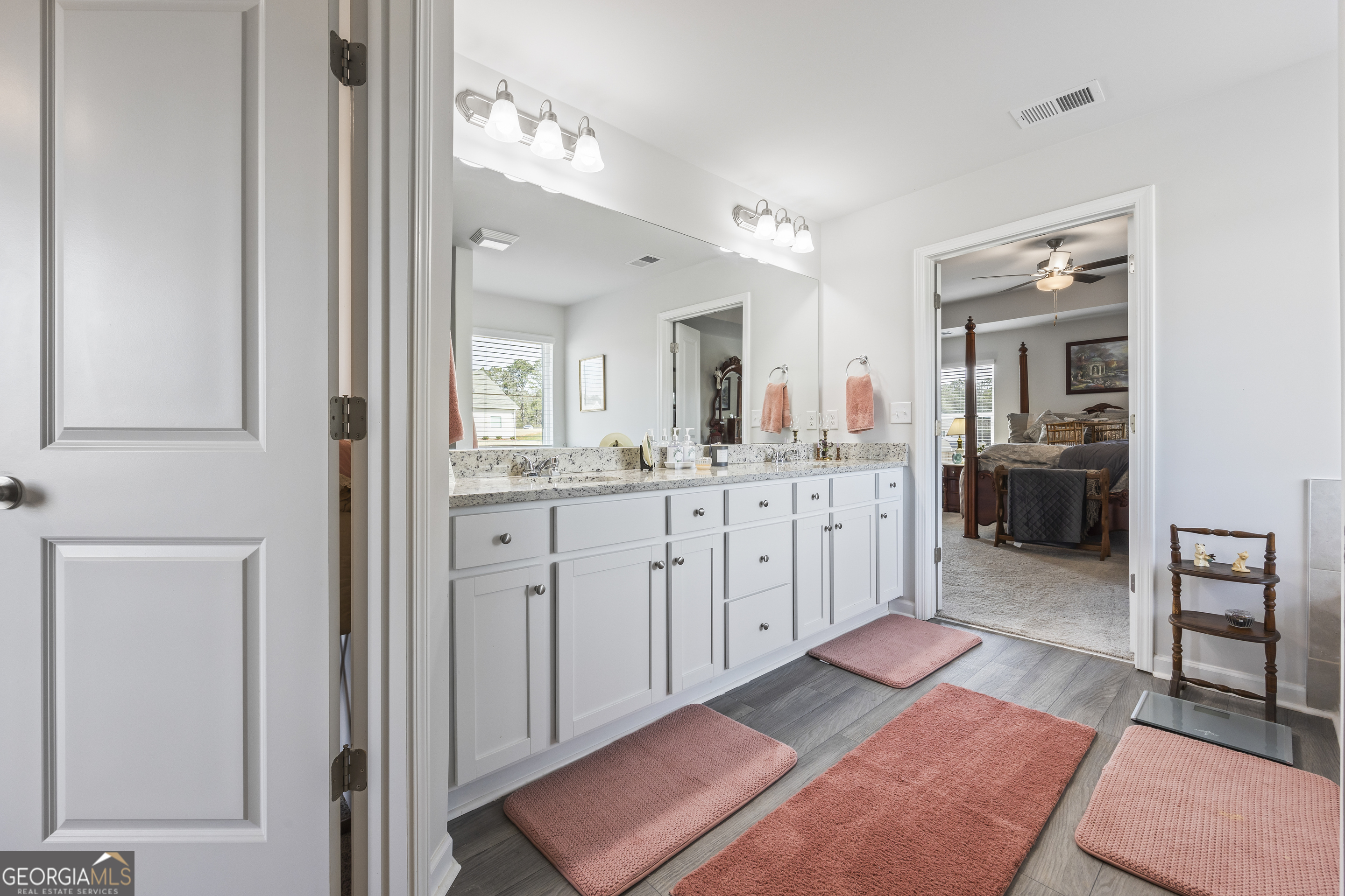 1064 Emmas Path Monroe, GA 30656 - Photo 39 of 55 a en suite bathroom with a sink a mirror and a shower