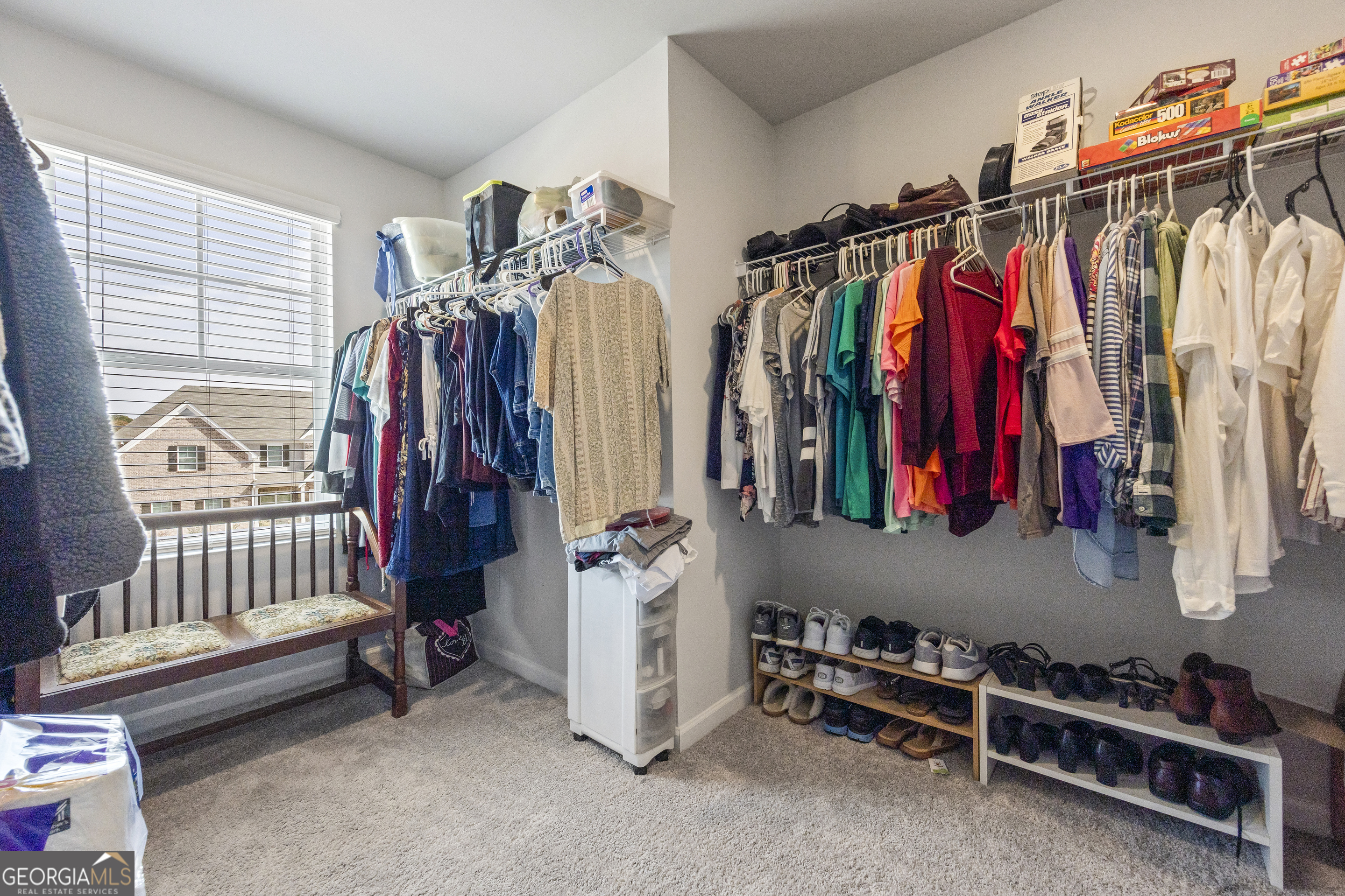 1064 Emmas Path Monroe, GA 30656 - Photo 40 of 55 a view of walk in closet with clothes and shoes