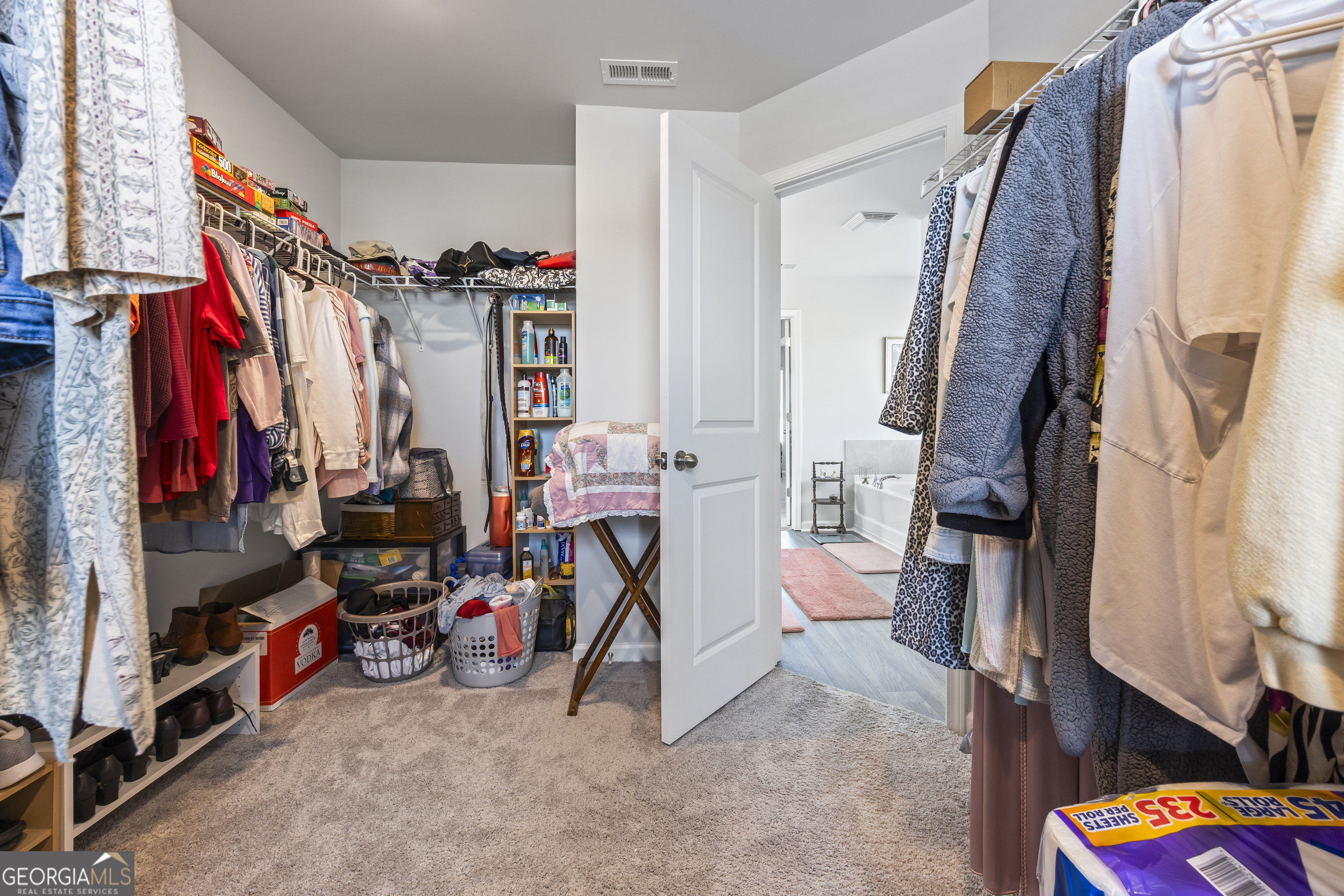 1064 Emmas Path Monroe, GA 30656 - Photo 41 of 55 a view of walk in closet with clothes and shoes