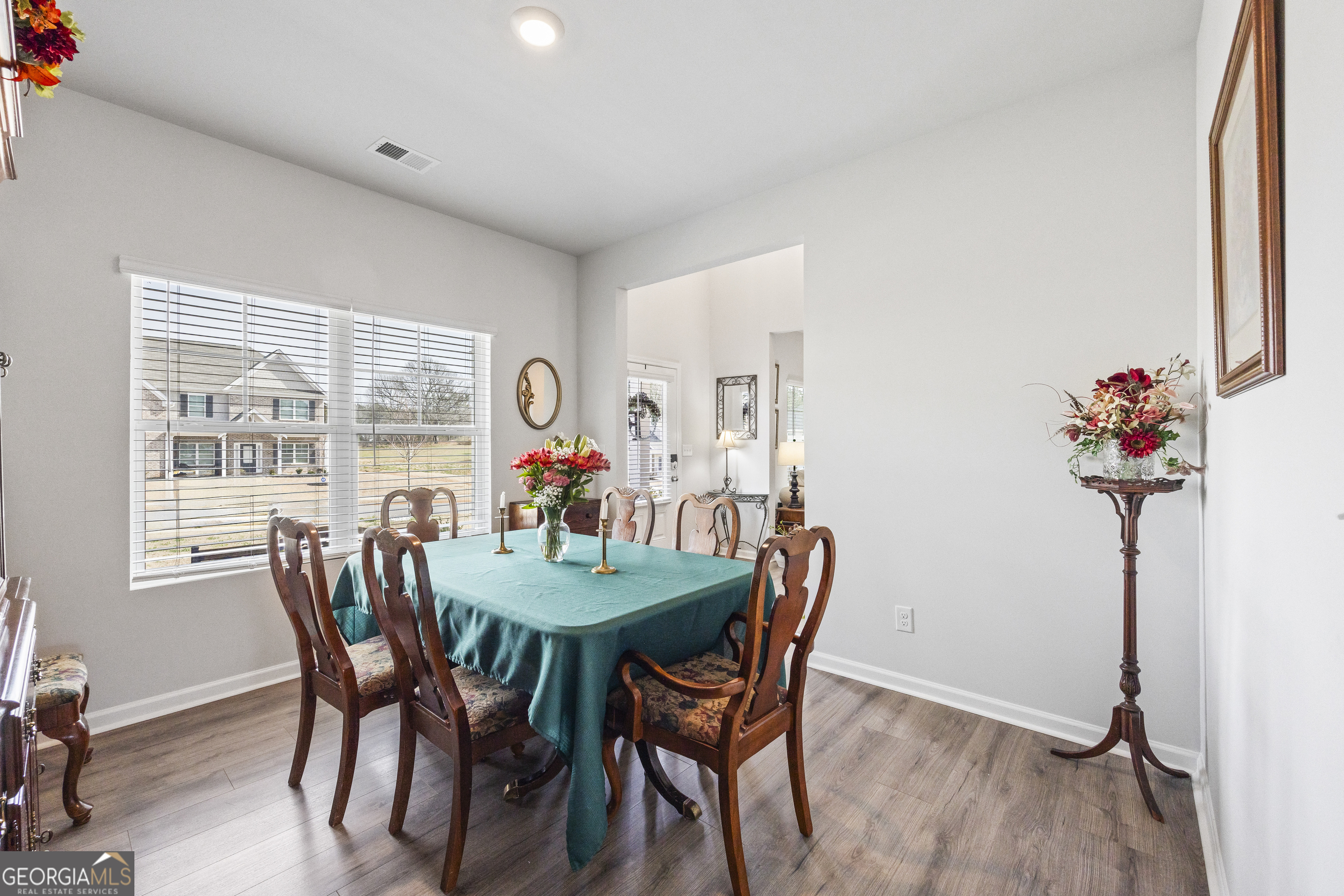 1064 Emmas Path Monroe, GA 30656 - Photo 10 of 55 a dining room with furniture potted plants and wooden floor