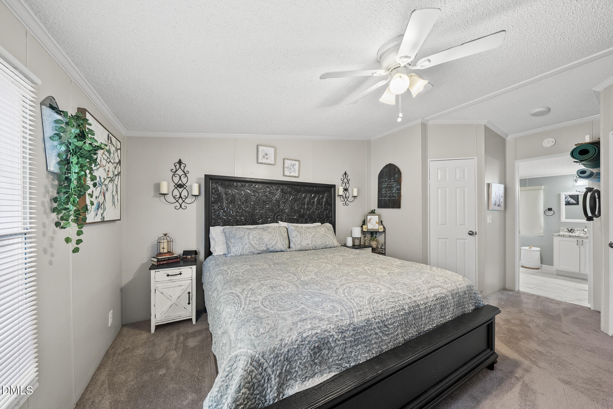 4703 Trinity Lane Rougemont, NC 27572 - Photo 14 of 55 a bedroom with a large bed and a chandelier