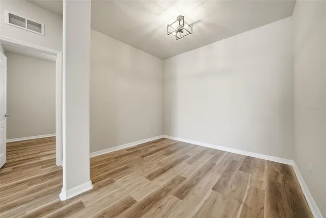 a view of a room with wooden floor