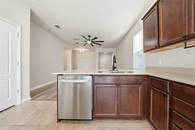 a bathroom with a sink a toilet a mirror and shower