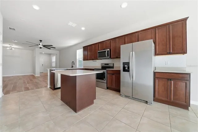 a kitchen with stainless steel appliances granite countertop a sink stove and cabinets