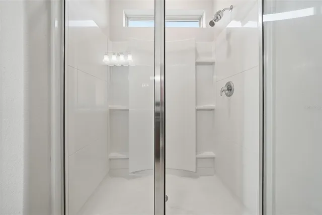 a bathroom with a glass shower door