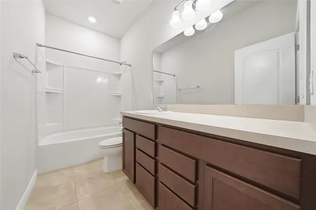 a bathroom with a sink a toilet a mirror and shower