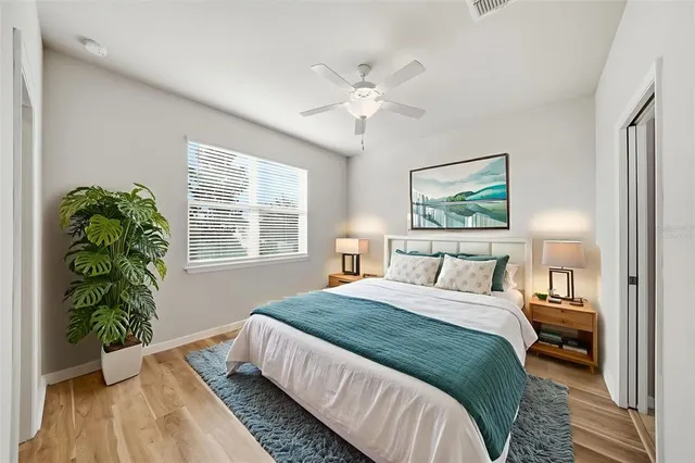 a bedroom with a bed and a large window