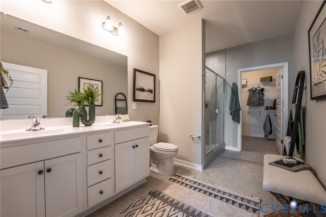 4001 Next Level Trace Midlothian, VA 23112 - Photo 22 of 42 a bathroom with a double vanity sink toilet and shower