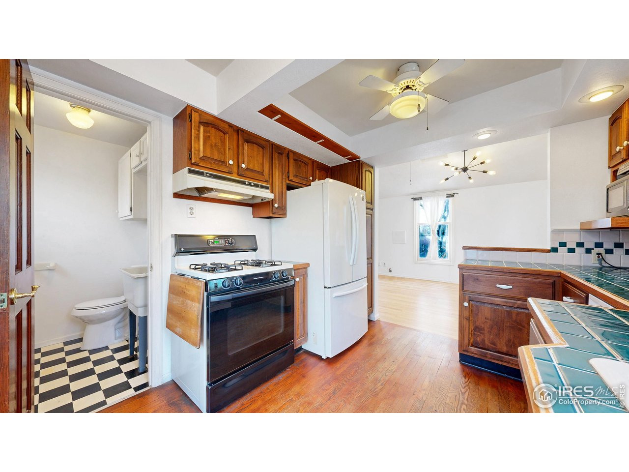1035 West Oak Street Fort Collins, CO 80521 - Photo 11 of 50 a kitchen with stainless steel appliances a stove a sink and a refrigerator