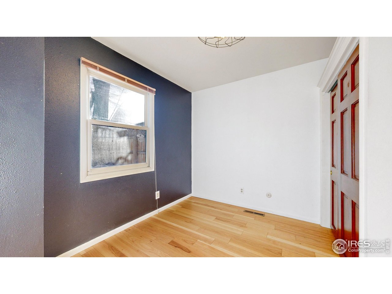 1035 West Oak Street Fort Collins, CO 80521 - Photo 20 of 50 a room with a bed and a painting on the wall