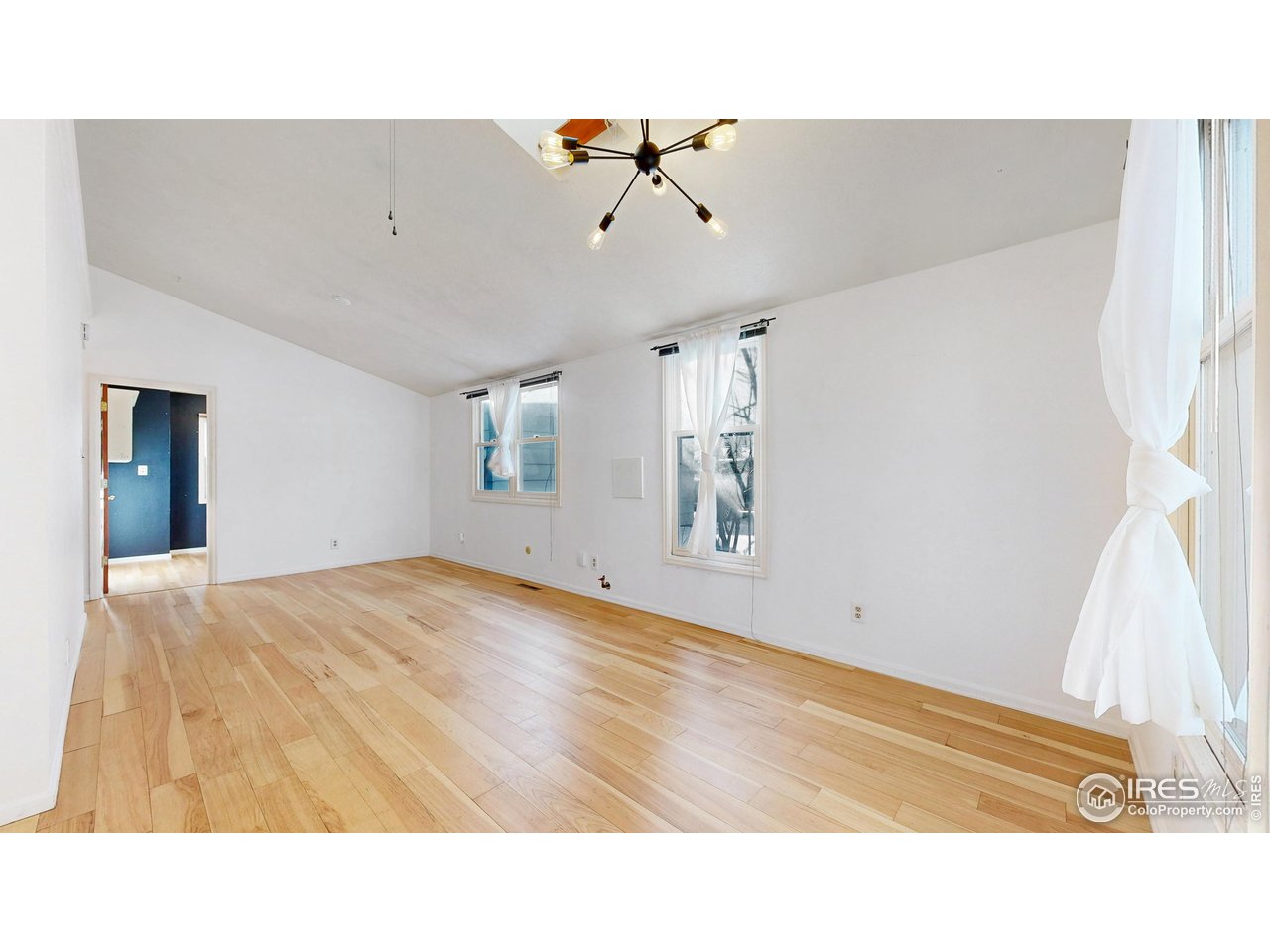 1035 West Oak Street Fort Collins, CO 80521 - Photo 5 of 50 a open hall with a hardwood floor and a ceiling fan