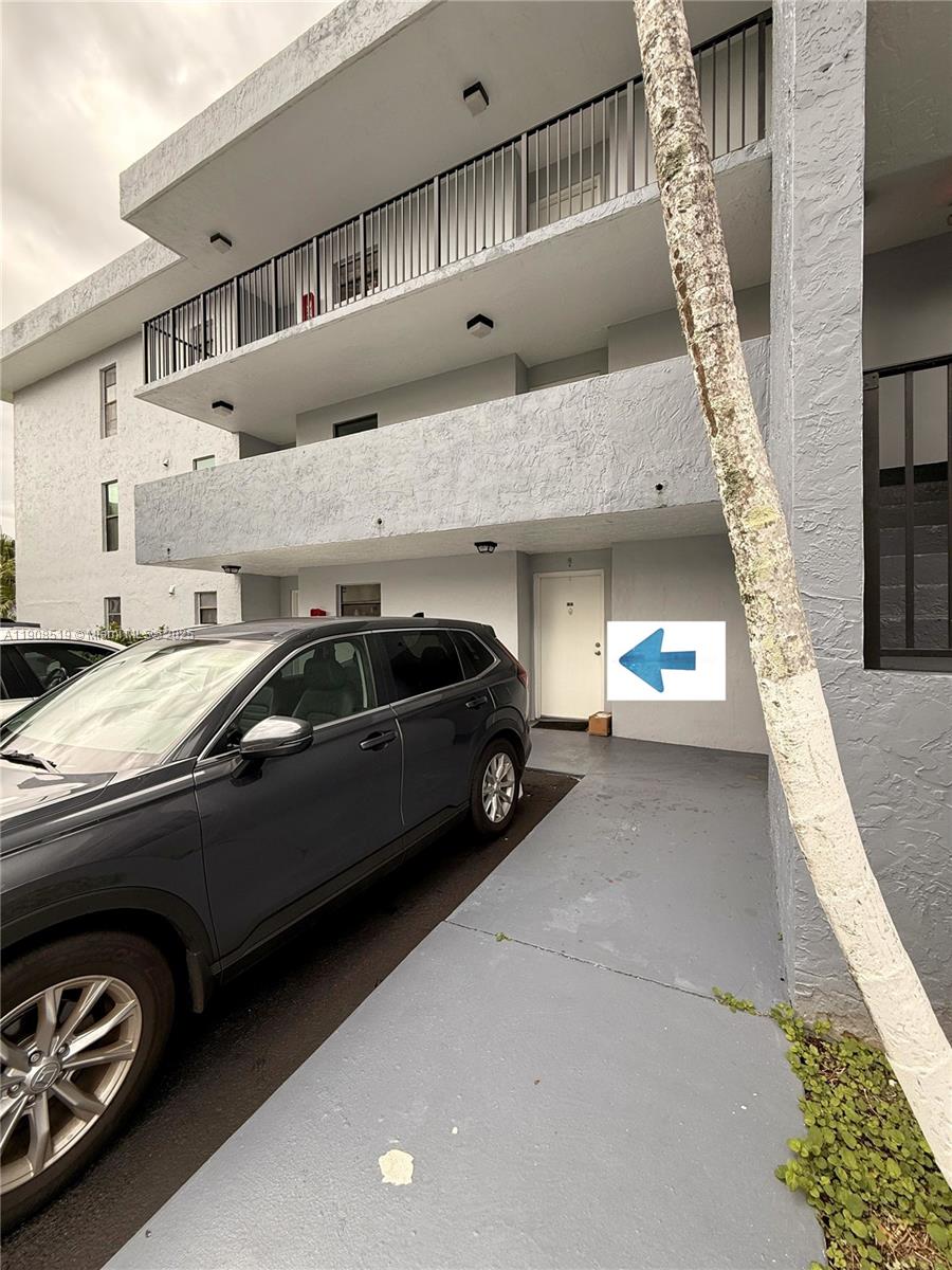 6300 Southwest 138th Court, Unit 102 Miami, FL 33183 - Photo 2 of 17 a view of parking garage with cars parked