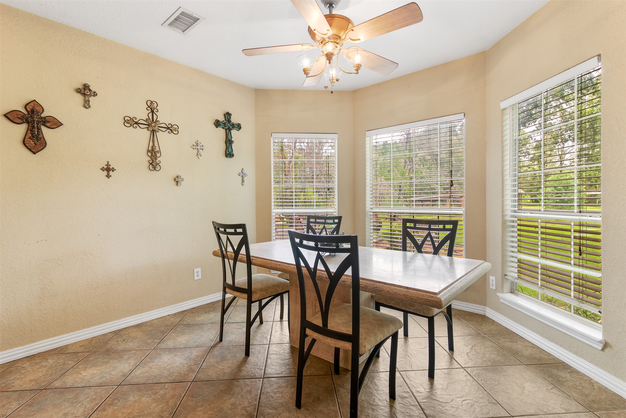 11692 Clark Lane Conroe, TX 77385 - Photo 9 of 35 The breakfast room has tile floors, ceiling fan and large bay window overlooking the peaceful backyard.