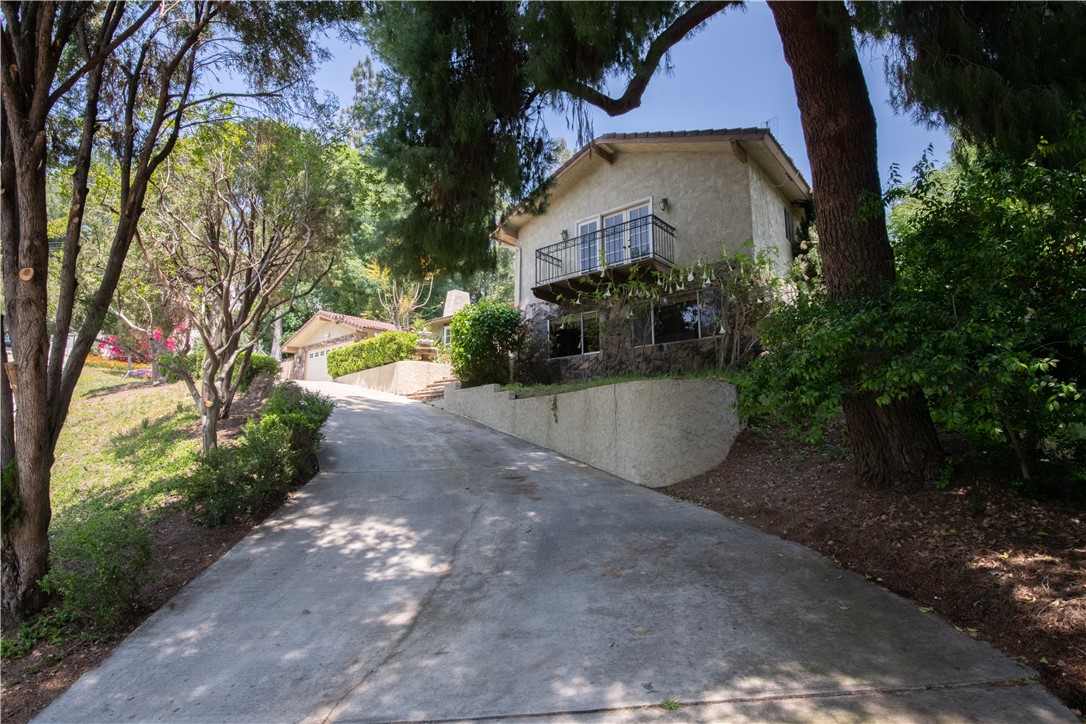 1981 Benbow Place Riverside, CA 92506 - Photo 1 of 1 a view of a yard with plants and a bench under an umbrella
