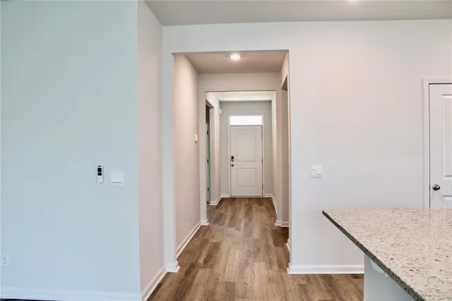 a view of a hallway with wooden floor