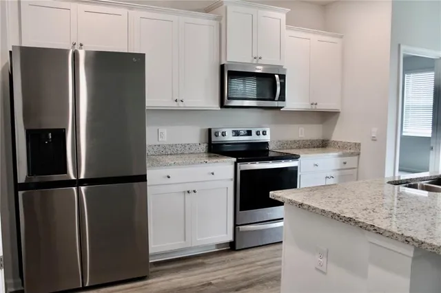 a kitchen with a refrigerator stove and sink