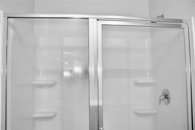 a bathroom with a glass shower door