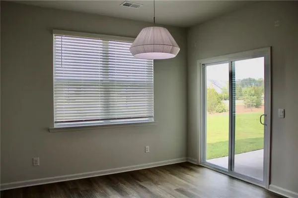 a room that has a window and wooden floor