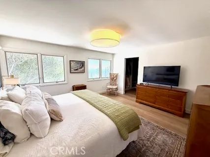 a bedroom with a bed and flat screen tv