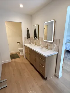a bathroom with a double vanity sink and mirror