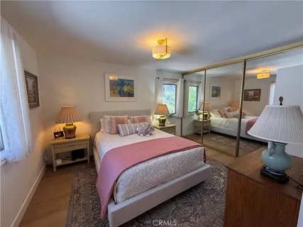 a bedroom with bed and a chandelier