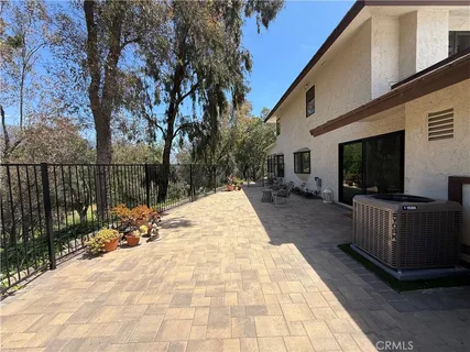 a view of a house with backyard and sitting area