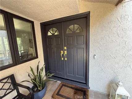 a view of front door with yellow lighting