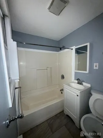 a bathroom with a sink mirror toilet and bathtub