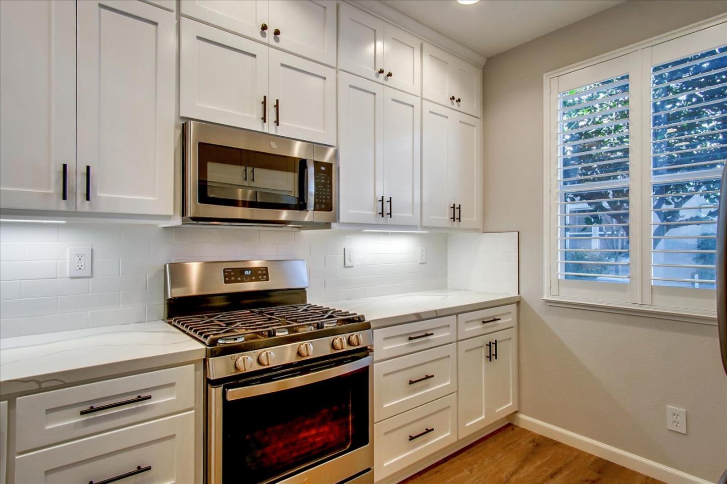 758 Tennyson Drive Gilroy, CA 95020 - Photo 11 of 39 a kitchen with granite countertop cabinets stainless steel appliances and a window