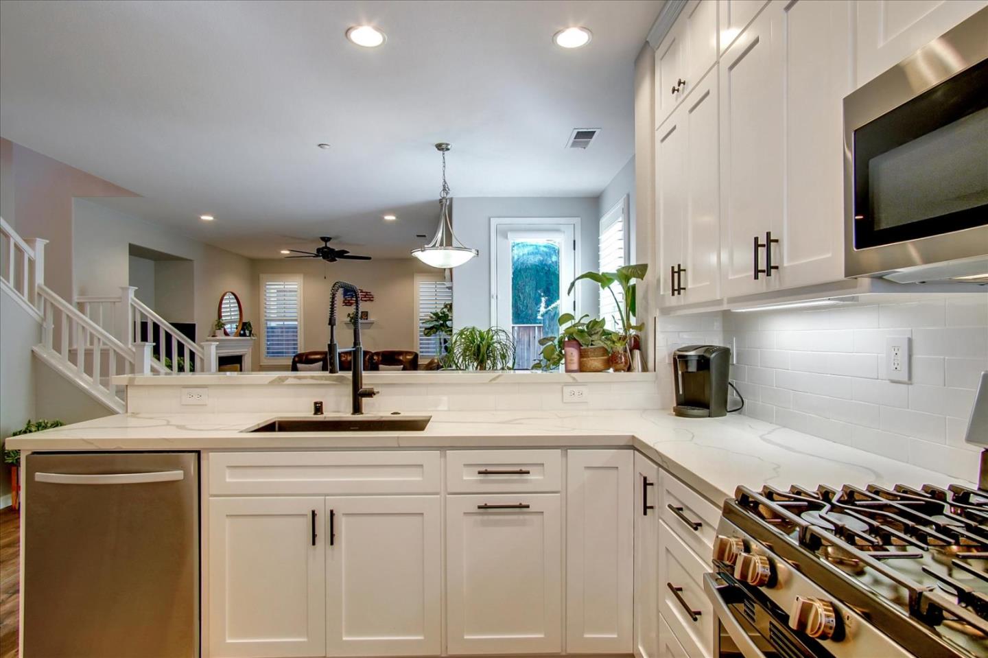 758 Tennyson Drive Gilroy, CA 95020 - Photo 13 of 39 a kitchen with stainless steel appliances granite countertop a sink and a stove