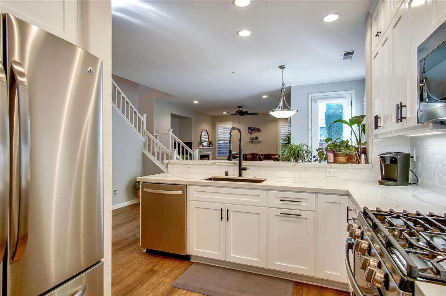 758 Tennyson Drive Gilroy, CA 95020 - Photo 14 of 39 a kitchen with white cabinets and stainless steel appliances