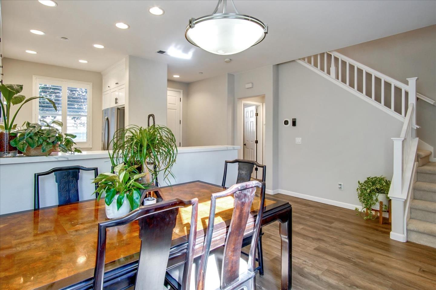 758 Tennyson Drive Gilroy, CA 95020 - Photo 15 of 39 a view of a dining room with furniture and a potted plant