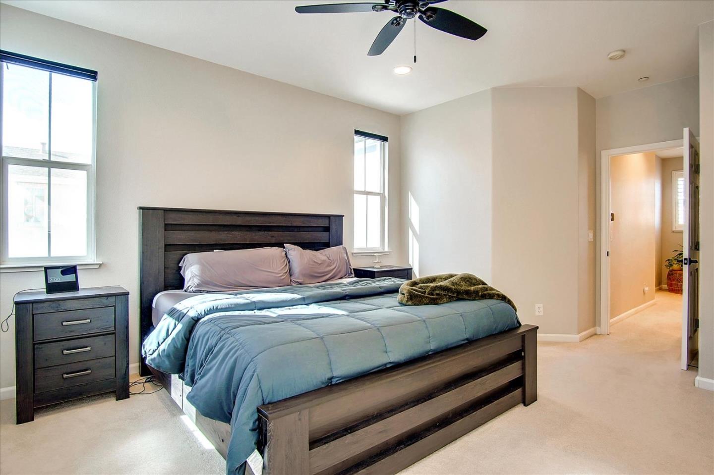 758 Tennyson Drive Gilroy, CA 95020 - Photo 22 of 39 a bedroom with a bed a chandelier and a window