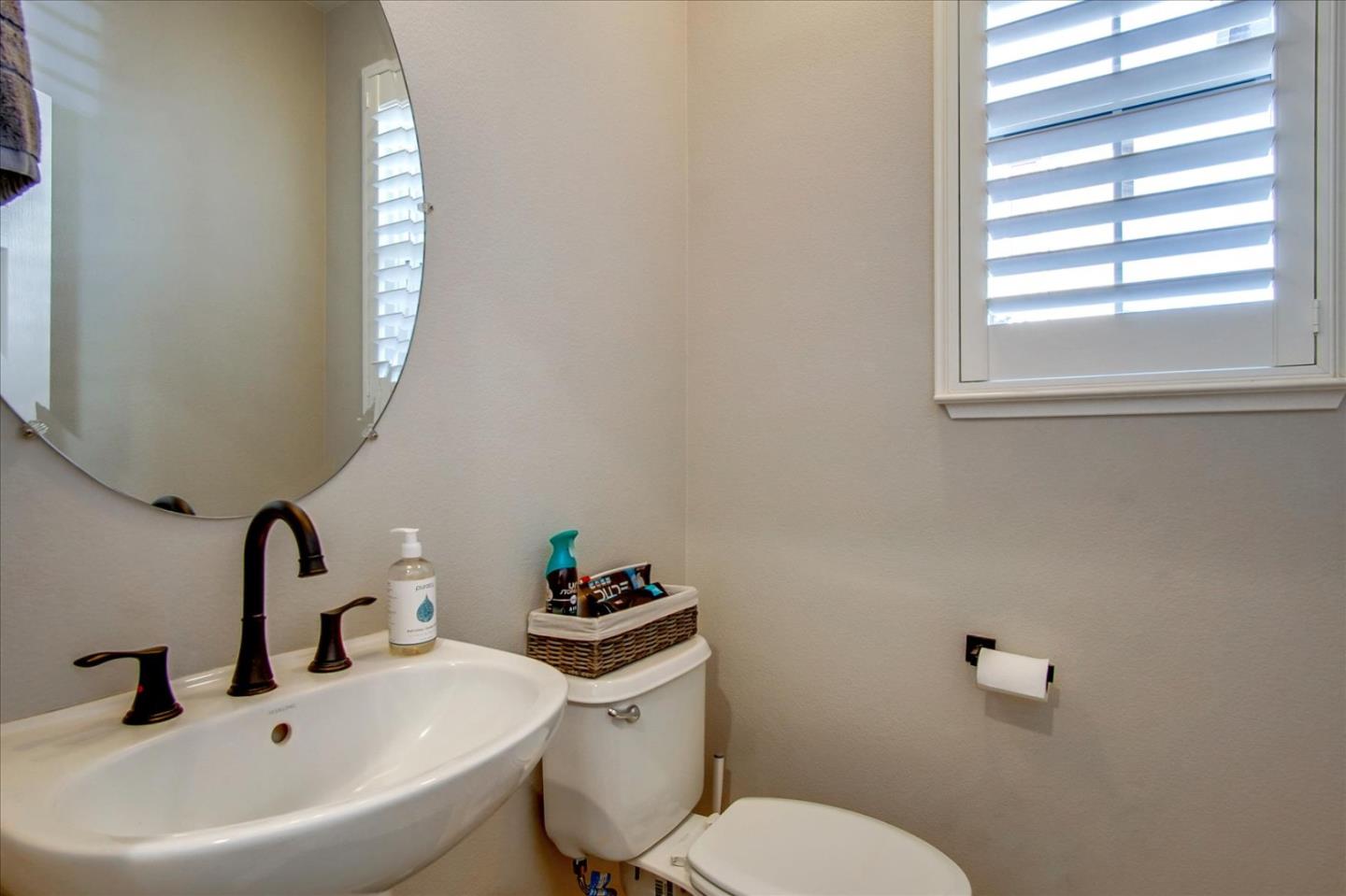 758 Tennyson Drive Gilroy, CA 95020 - Photo 28 of 39 a bathroom with a sink mirror and toilet
