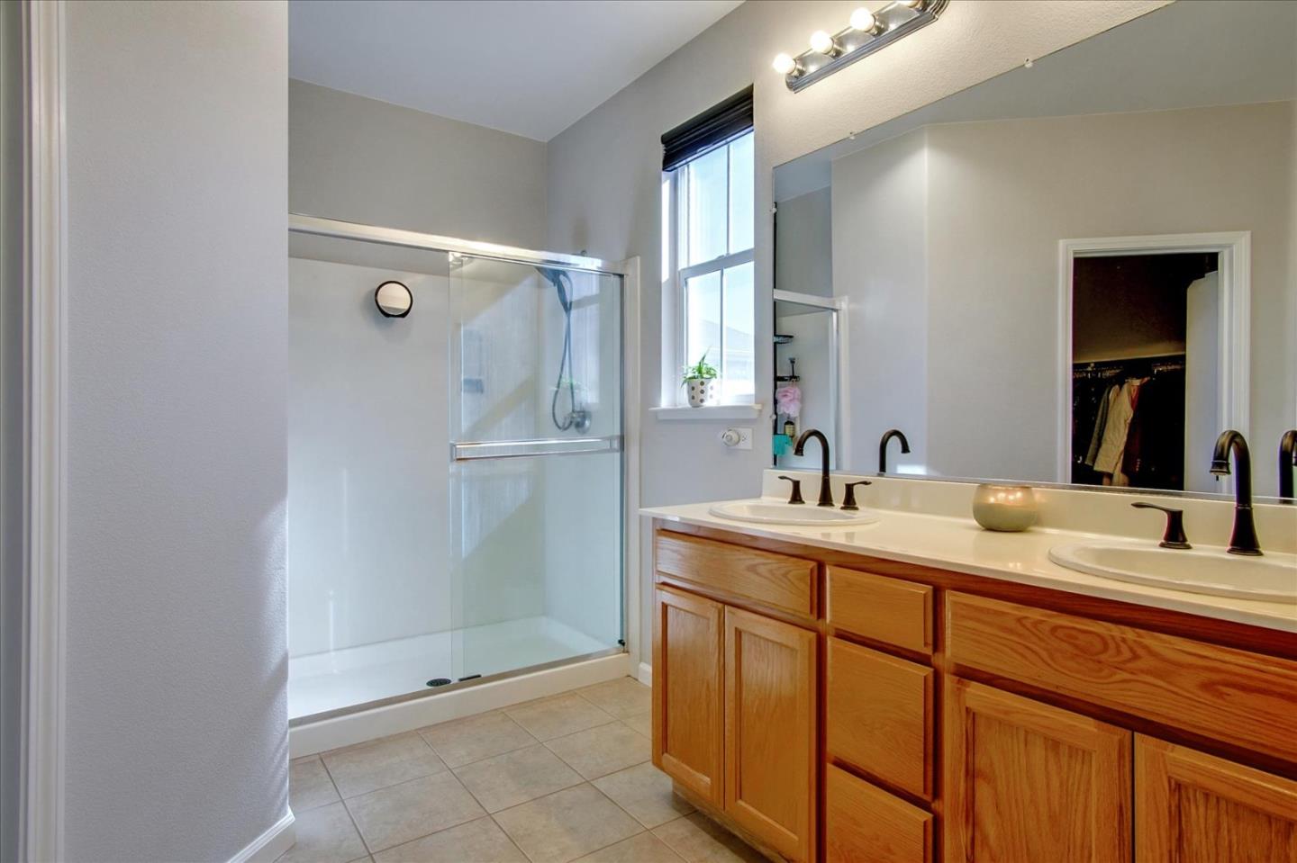 758 Tennyson Drive Gilroy, CA 95020 - Photo 29 of 39 a bathroom with a granite countertop sink and a mirror