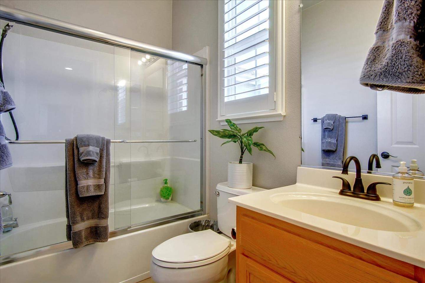 758 Tennyson Drive Gilroy, CA 95020 - Photo 30 of 39 a bathroom with a granite countertop sink a toilet and shower